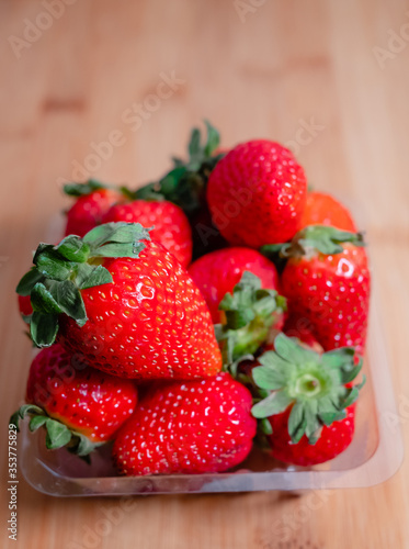 Fresh red strawberries on a wooden board