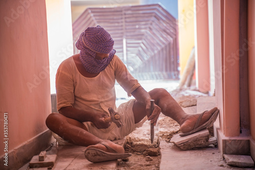  jaipur. Rajasthan. India - may 21, 2020 Asia people work hard about construction in factory with wearing mask (covid19 )