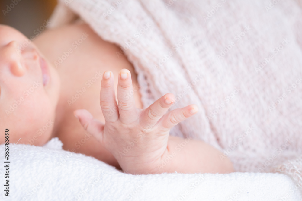 Selective focus tiny finger hand of newborn baby movement using small muscle, infant open her eyes looking for mother with curiosity cannot see anything, toddler lie down on bed at home or hospital Selective focus tiny finger hand of newborn baby movement using small muscle, infant open her eyes looking for mother with curiosity cannot see anything, toddler lie down on bed at home or hospital