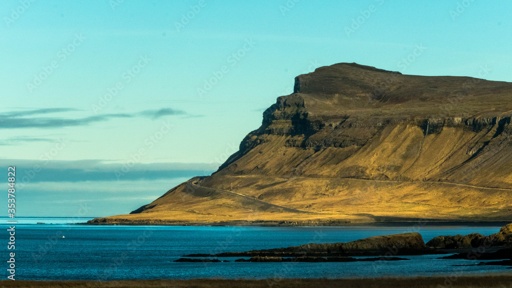 In the west of Iceland a mountain near the sea surrounded it by the road