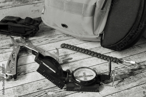 Compass, multitool and a backpack for a hike