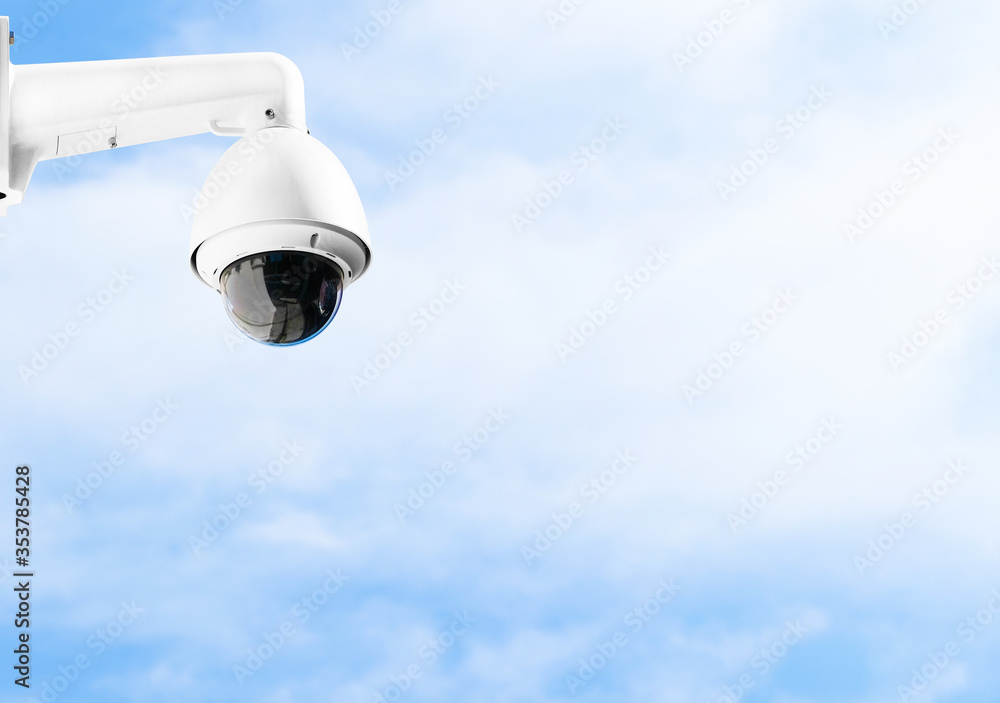 Modern public CCTV camera on building wall with bright sky background. Intelligent reccording cameras for monitoring all day and night. Concept of surveillance and monitoring with copy space. Modern public CCTV camera on building wall with bright sky background. Intelligent reccording cameras for monitoring all day and night. Concept of surveillance and monitoring with copy space.