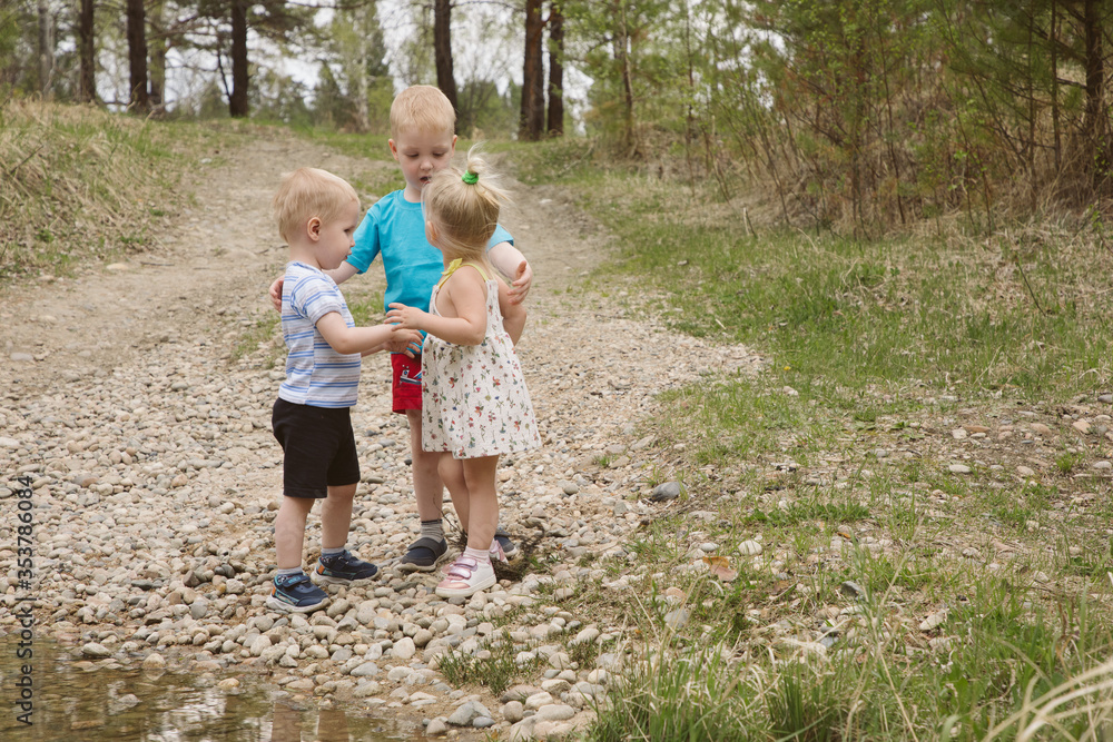 Children on a river in a forest catch fish Children on a river in a forest catch fish