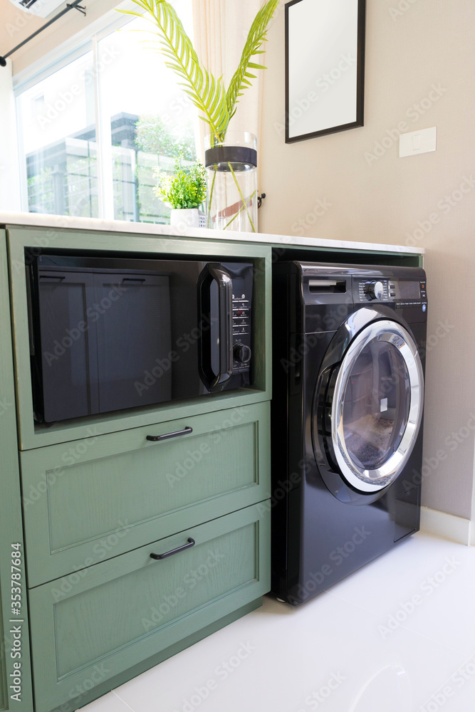 A section of kitchen room with washing machine in a home A section of kitchen room with washing machine in a home