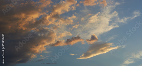Panorama beautiful Cumulus clouds, with the color changing from dark blue to white, on the blue sky during sunset