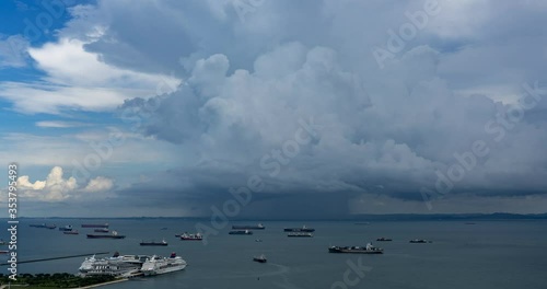 Time lapse video of Heavy rain shower cloud in the ocean photo