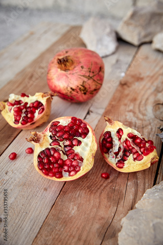 ripe organic pomegranate on teh wooden background