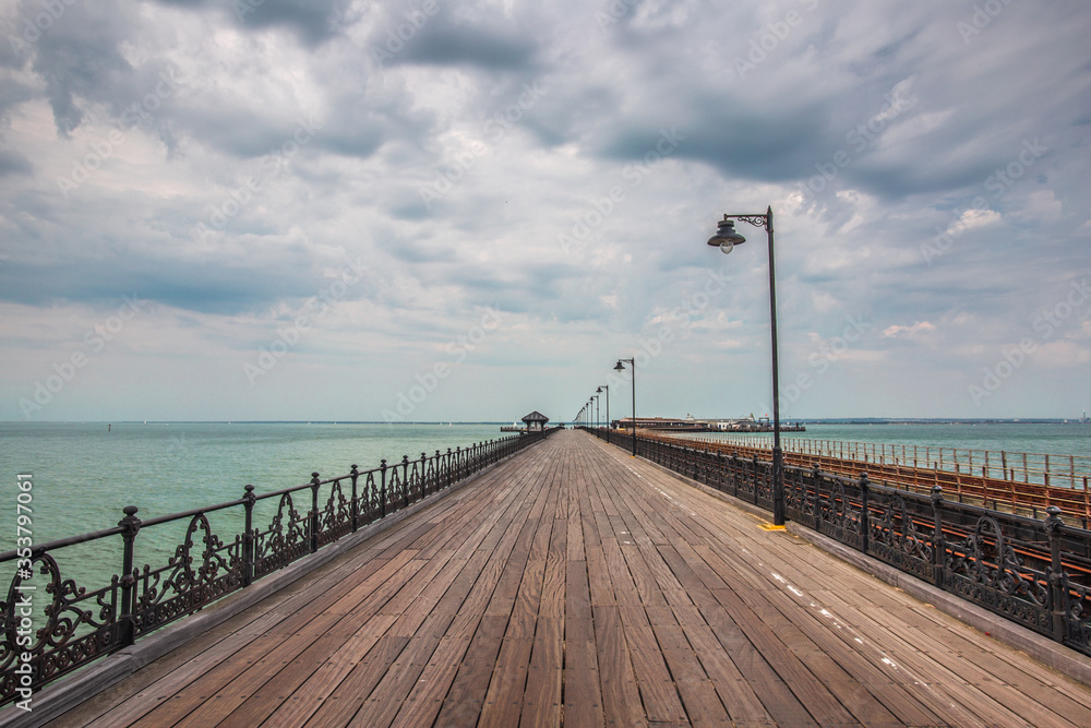 Amazing wooden bridge in Ryde Isle of Wight UK with stunning sky and turquoise ocean