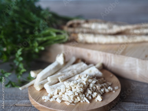 Medical and food background.Parsley and parsley root on a wooden background.Useful plant.
