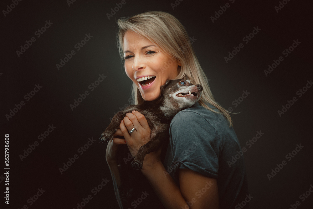 Young pretty woman with her Toy Terrier dog