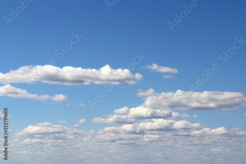 Fototapeta Naklejka Na Ścianę i Meble -  White fluffy clouds on a background of blue sky in summer. The concept of weather and climate.