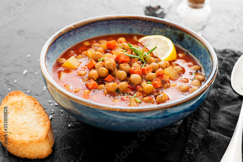 Slika na platnu Appetizing chickpea soup served with lemon and bread.