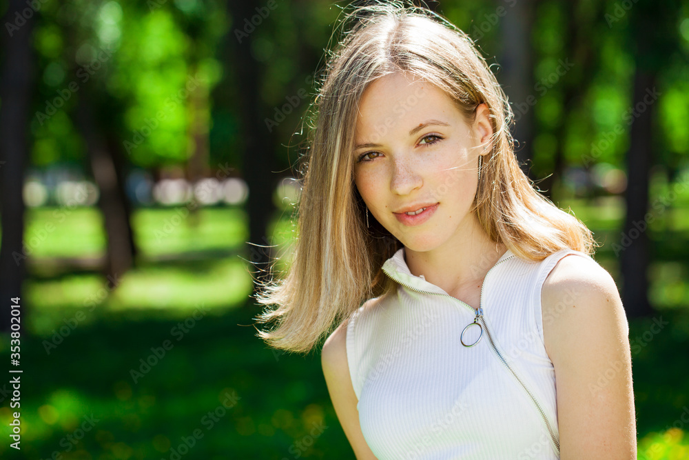 Portrait of a young beautiful brunette girl in summer park Portrait of a young beautiful brunette girl in summer park