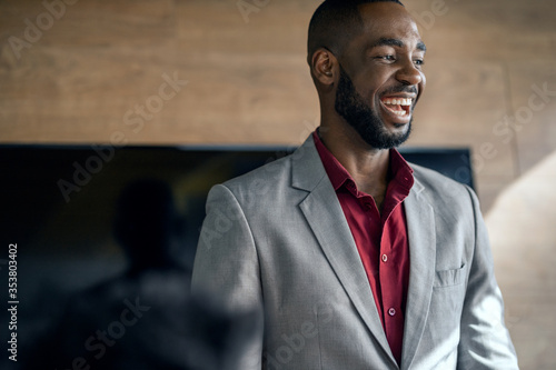 African manager laughing during a meeting with his staff photo
