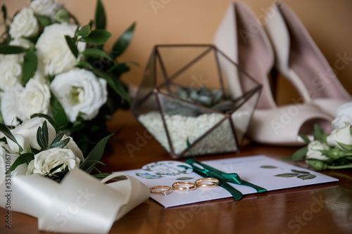 wedding gold rings with bride shoes and decor