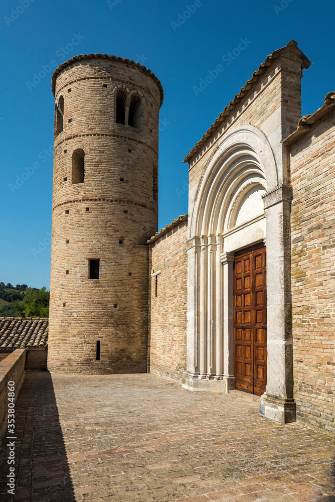 italy, Marche, Corridonia, Church of San Claudio, front with central entrance, two towers on the sides,medieval church facade, view from below