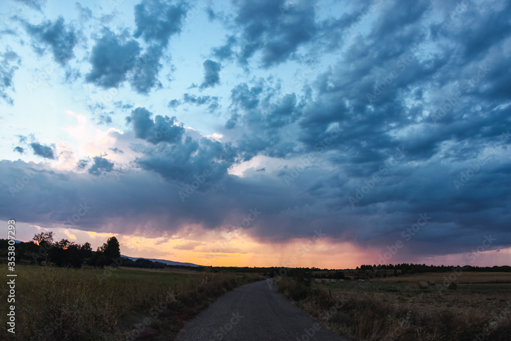 Fototapeta premium The road goes directly to the thunderstorm seen far away. The weather is changing