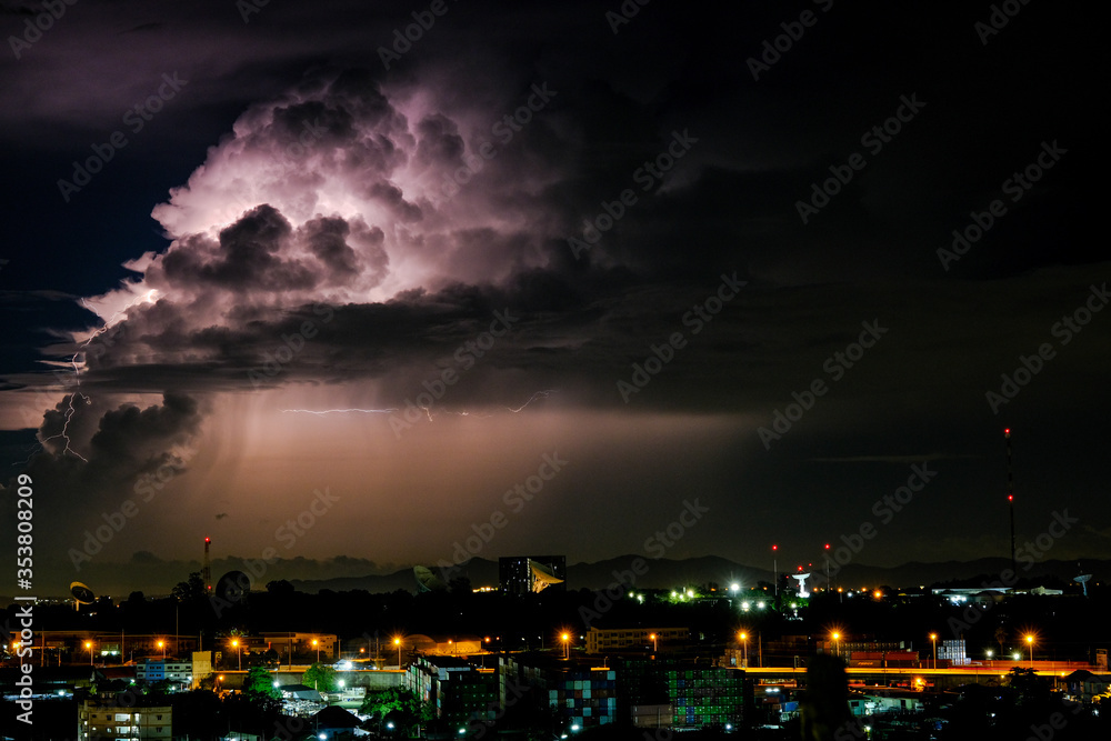 Naklejka premium Cloudy with Bright lightning bolt strikes in the rural landscape of small city and satellite station