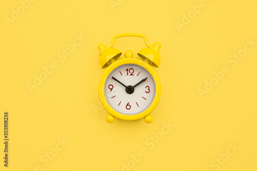 Yellow alarm clock Isolated on yellow trendy background. Rest hours time of life good morning night wake up awake concept