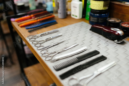Set of hairdressing tools on table. Clean metal scissors