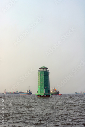 green lighthouse on the sea