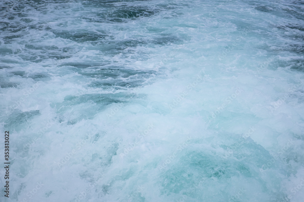 Splashing wave and white air foam bubble from ferry boat. The view behind a ferry boat.