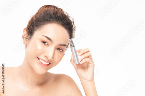 Beauty asian woman brown hair looking smile in camera happiness and hold bottle cosmetic cream lotion and cheerful with make up brush,Beauty Concept on white background.