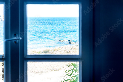 A window with a view of the sea in Greece