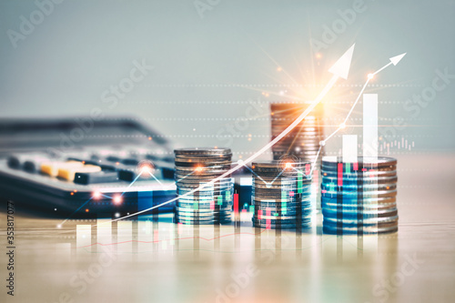 financial market trade chart, arrow on stack of money coins growing, arranged as a graph shown in the virtual screen. the concept of financial, business and economic exchange rates is growing. photo