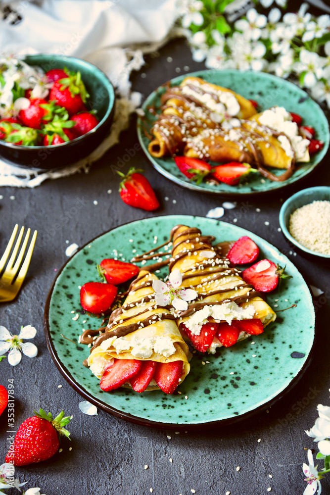 Pancakes with strawberries and chocolate. Spring still life with a sweet breakfast. Pancakes with strawberries and chocolate. Spring still life with a sweet breakfast.