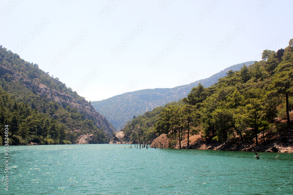 Turquoise lake in the middle of green mountains and rocks. Landscape. Turquoise lake in the middle of green mountains and rocks. Landscape.