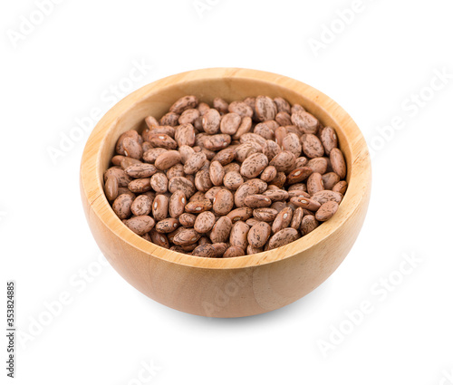 Pinto beans in wooden bowl an isolated on white background