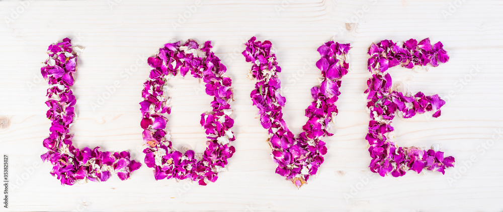 Word Love made of purple rose petals Word Love made of purple rose petals