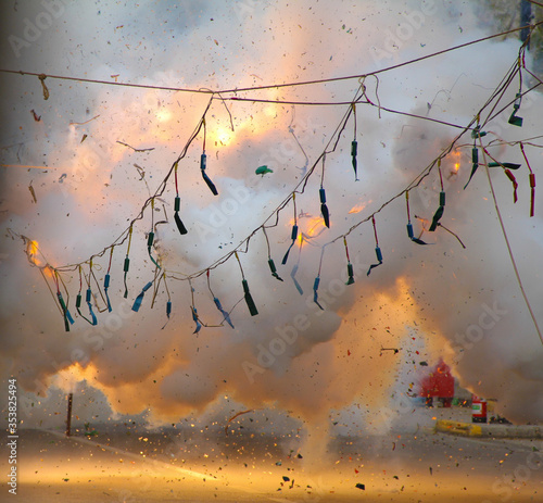 Explosions of firecrackers hanging on ropes in the fallas de valencia celebrating saint joseph's day photo