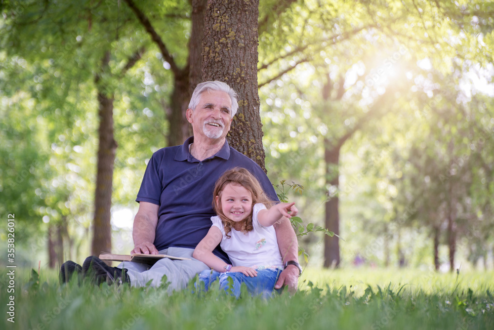 Grandfather and his granddaughter playing outdoors Grandfather and his granddaughter playing outdoors