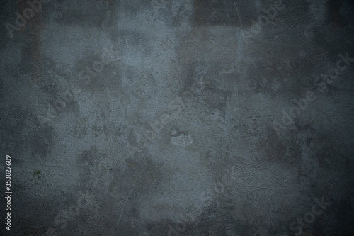 dark dirty concrete background texture stained with blue tint and copy space