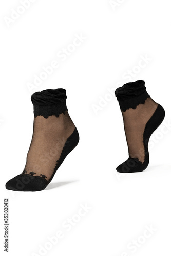 Detailed shot of black nylon sheer socks with black serrated pattern, black toes, bottoms and rims. The pair of socks is isolated on the white background. 