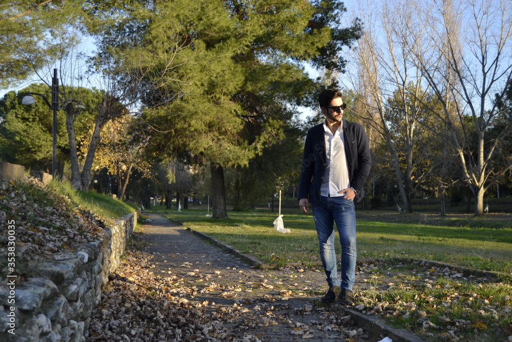 Obraz premium Young handsome man at sunset. Millenial influencer