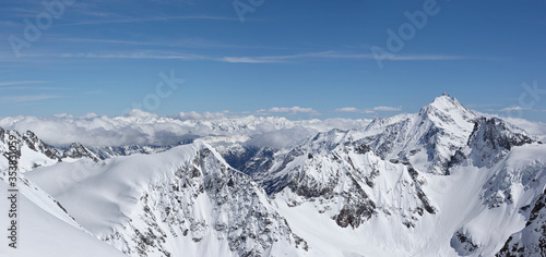 Panoramic of snowy mountain landscape with blue sky and detail