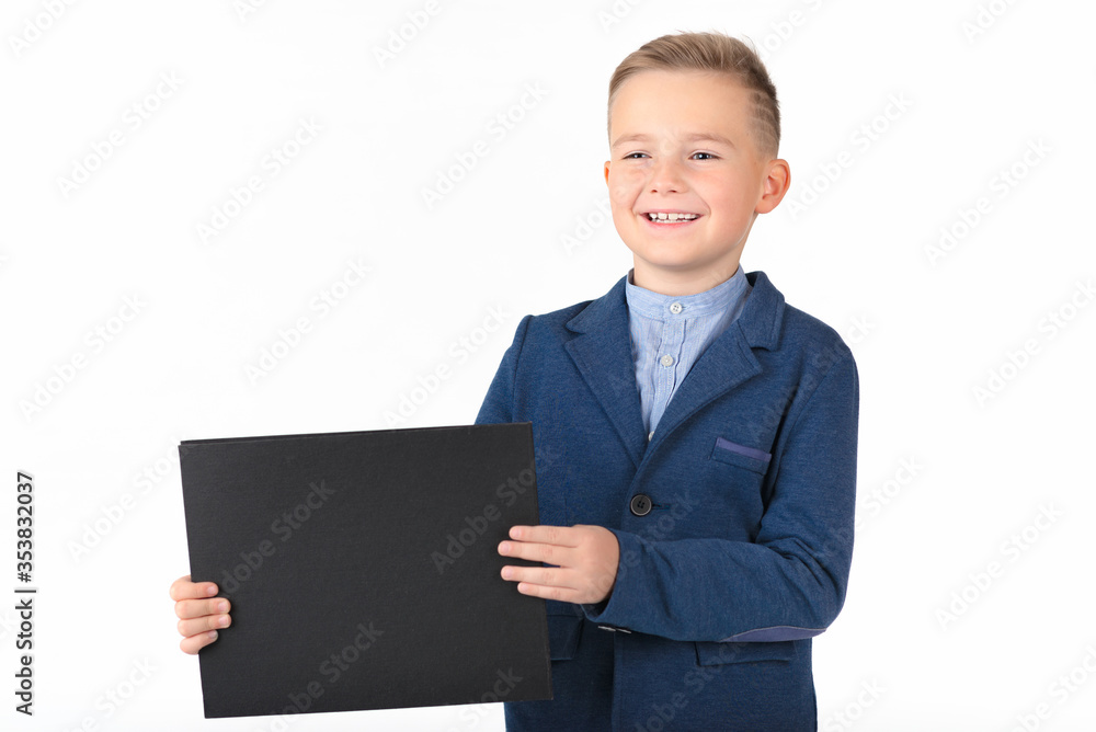 Happy exited caucasian young boy showing and displaying blank black board ready for your text or product.White background isolated. Happy exited caucasian young boy showing and displaying blank black board ready for your text or product.White background isolated.