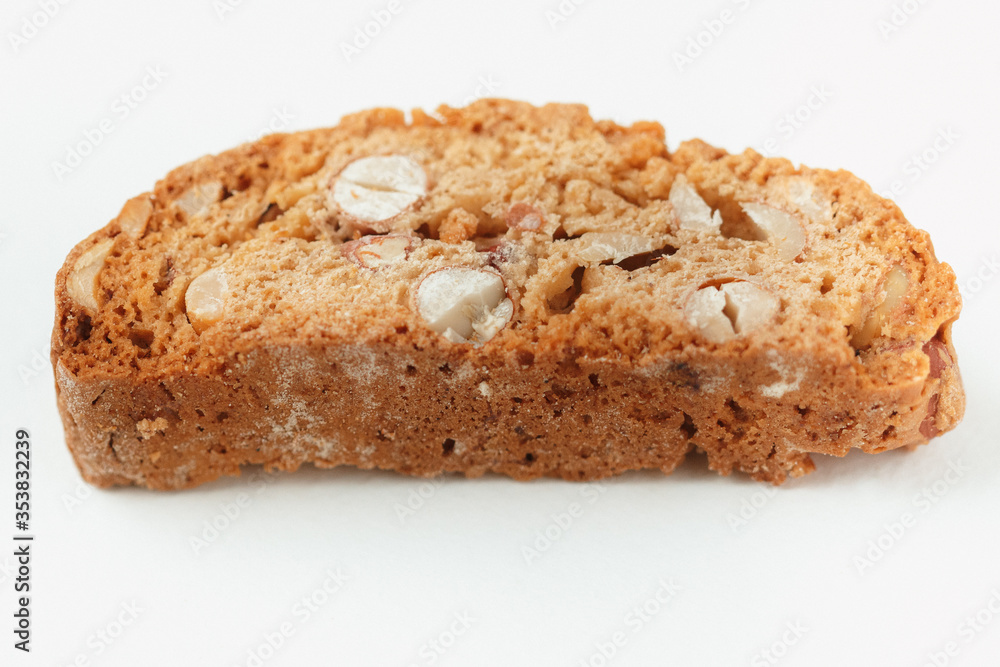 Popular Italian Biscotti or Cantucci biscuit cookie stuffed with nuts isolated on white background with copy space.Side view closeup Popular Italian Biscotti or Cantucci biscuit cookie stuffed with nuts isolated on white background with copy space.Side view closeup