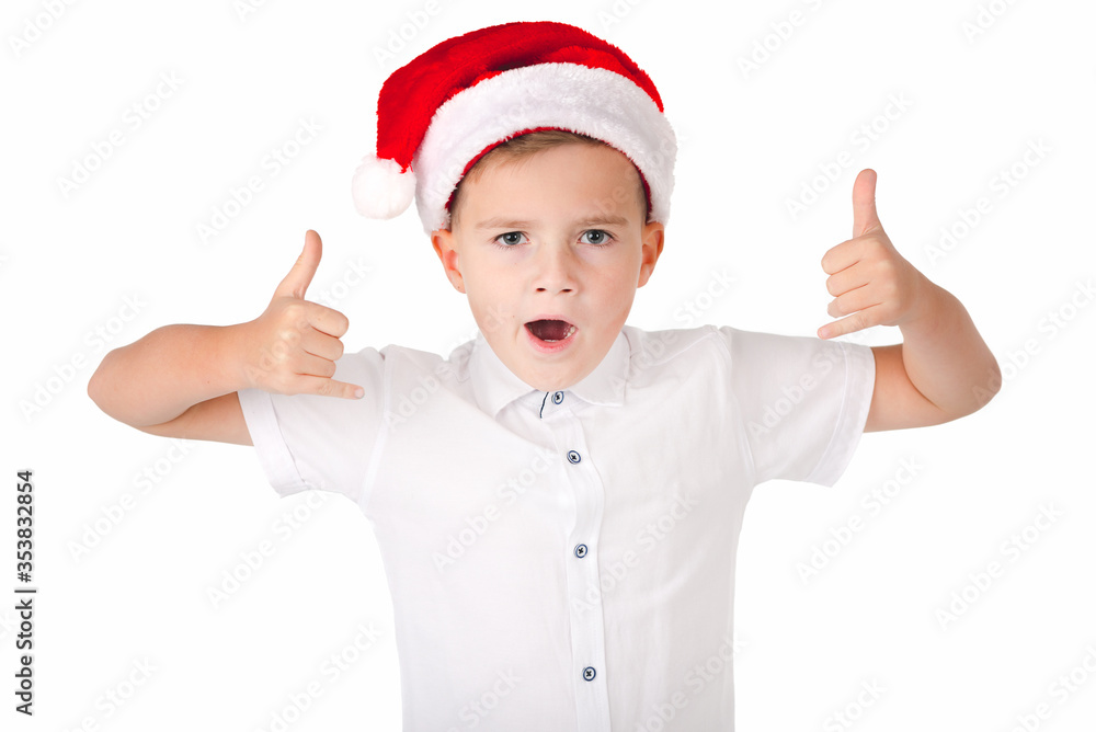 Portrait of happy young caucasian boy in Santa hat with thumbs up isolated on white background Portrait of happy young caucasian boy in Santa hat with thumbs up isolated on white background