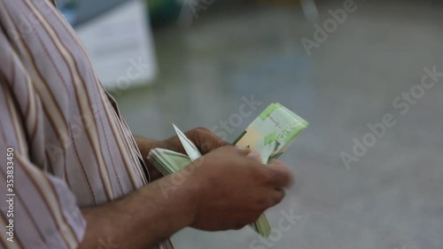 Hands counting libyan dinar