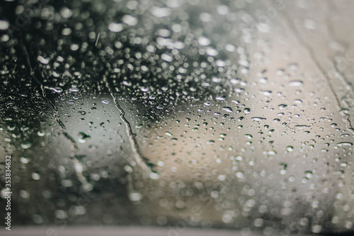 Rain on glass in spring, drops closeup