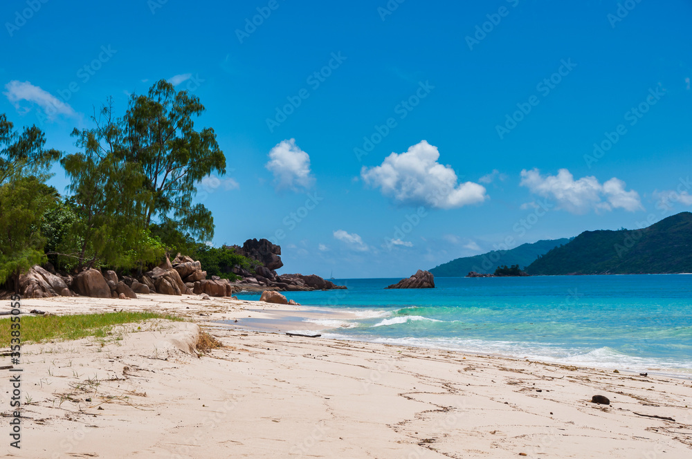 The coastline white sand beach of the island of Curieuse, Seychelles