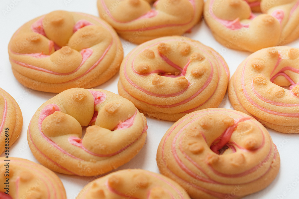 Cookie biscuit with pink sugar cream icing isolated on white background Cookie biscuit with pink sugar cream icing isolated on white background