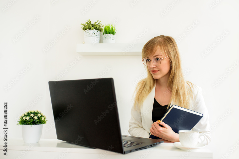 Fototapeta premium Tax advice to lawyer or accountant.Female lawyer giving a consultation online at home. Young girl student at a laptop. Online counseling, online education, distance learning.