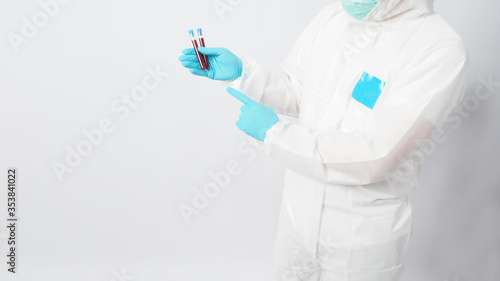 Fototapeta Naklejka Na Ścianę i Meble -  Male model with PPE cloth and Hand wearing doctor glove is holding blood collection tube on white background.