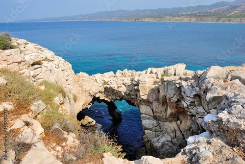 Natural rock bridge at the Lara Bay on Akamas peninsula with the turquoise waters of Mediterranean Sea in northwest extremity of Cyprus photo