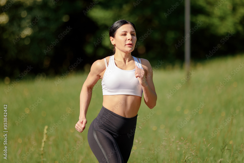 Beautiful young female runner in the green forest. Beautiful young female runner in the green forest.
